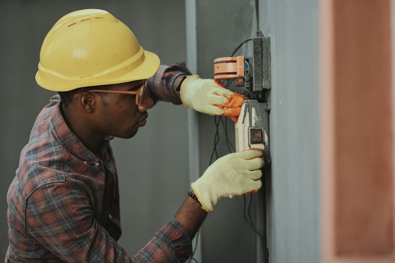 Engineer servicing fire and security systems
